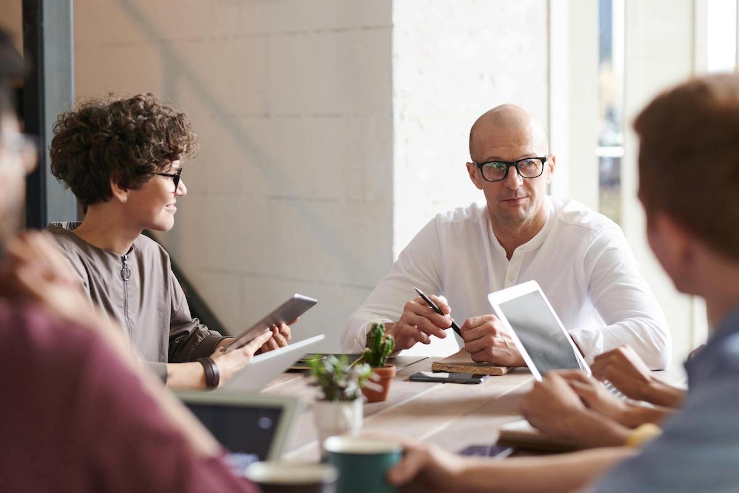 Image of a man and woman at a table holding a meeting